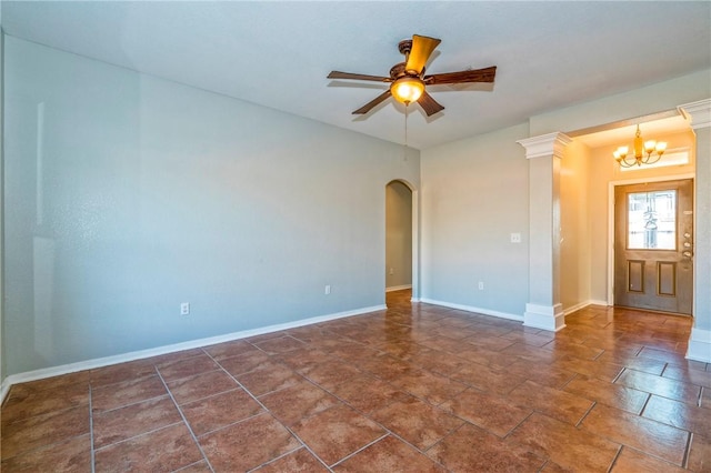 spare room with ceiling fan with notable chandelier and ornate columns