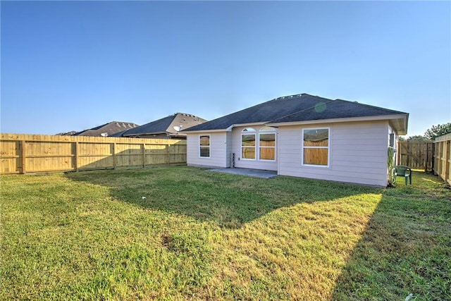 back of property featuring a yard and a patio area