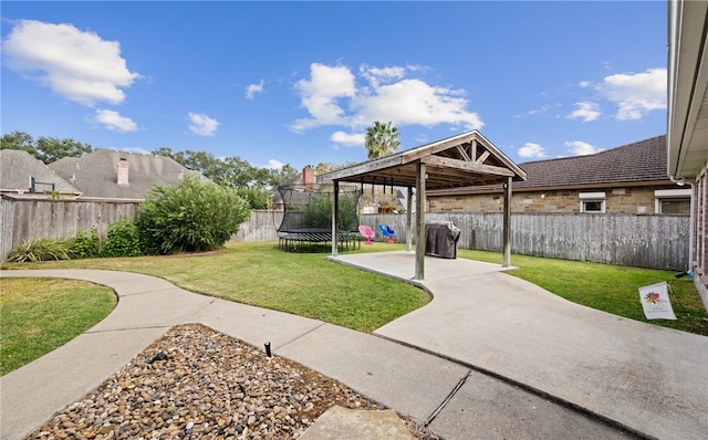 view of yard featuring a patio and a trampoline