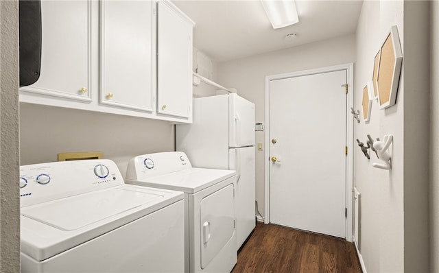 washroom with cabinets, dark hardwood / wood-style floors, and washing machine and dryer