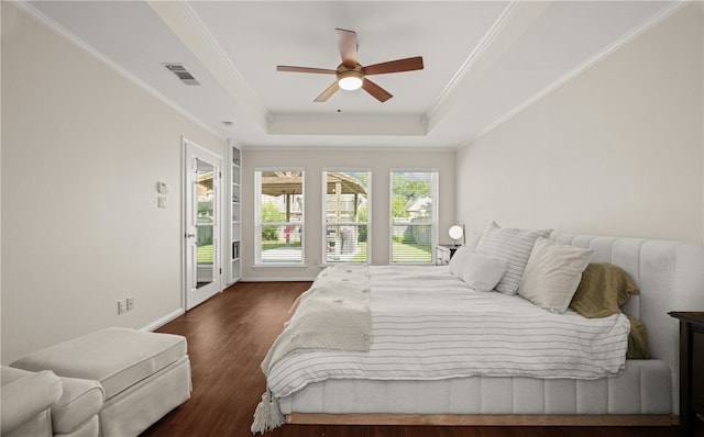 bedroom with dark hardwood / wood-style flooring, access to exterior, ceiling fan, a raised ceiling, and crown molding