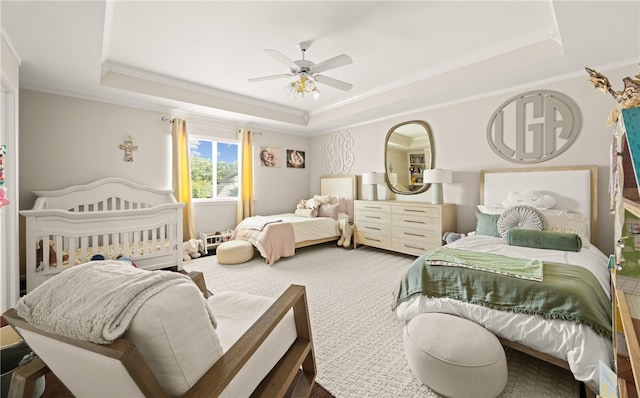 bedroom featuring ornamental molding and a tray ceiling