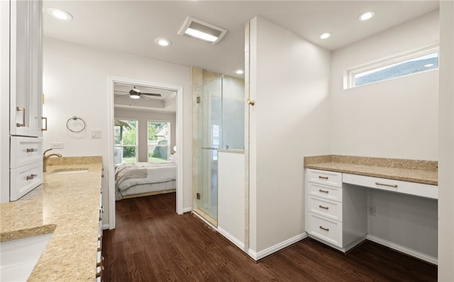 bathroom featuring hardwood / wood-style flooring, vanity, and a shower with door