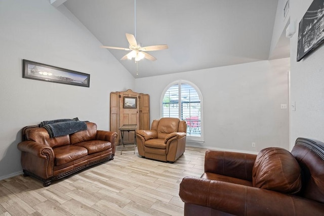 living room featuring ceiling fan, light wood-type flooring, and high vaulted ceiling