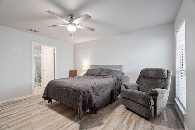 bedroom with ensuite bathroom, ceiling fan, and light wood-type flooring