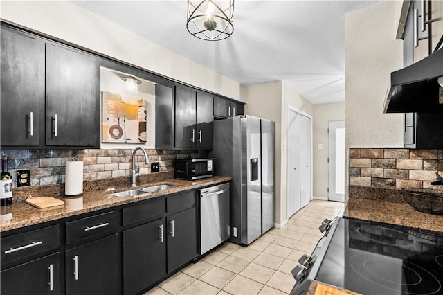 5213 Inverness Dr, Corpus Christi, TX 78413 - kitchen featuring stainless steel appliances, dark cabinets, and backsplash