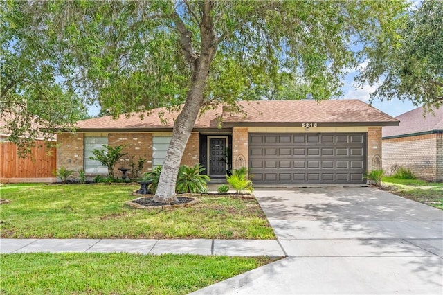 5213 Inverness Dr, Corpus Christi, TX 78413 - view of front facade featuring a garage, brick siding, and concrete driveway