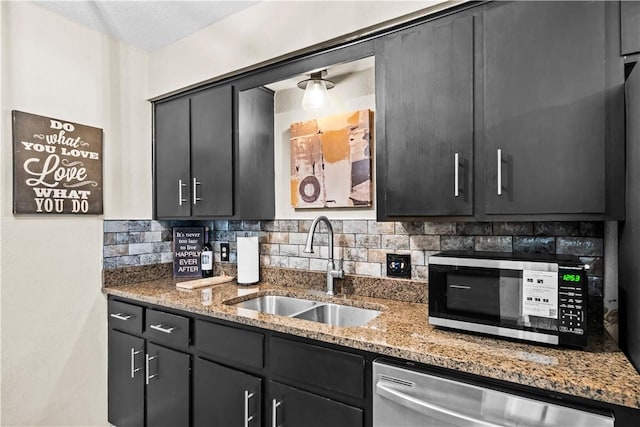 5213 Inverness Dr, Corpus Christi, TX 78413 - kitchen with appliances with stainless steel finishes, tasteful backsplash, light stone countertops, and dark cabinets
