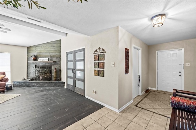 5213 Inverness Dr, Corpus Christi, TX 78413 - tiled entrance foyer featuring french doors, a textured ceiling, and a fireplace