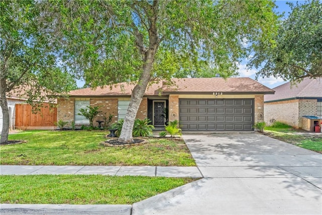 5213 Inverness Dr, Corpus Christi, TX 78413 - view of front facade featuring an attached garage, brick siding, and driveway
