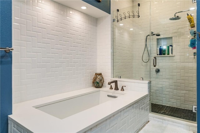 full bath with tiled shower