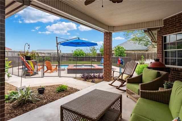 view of patio with a fenced backyard, a fenced in pool, ceiling fan, and an in ground hot tub