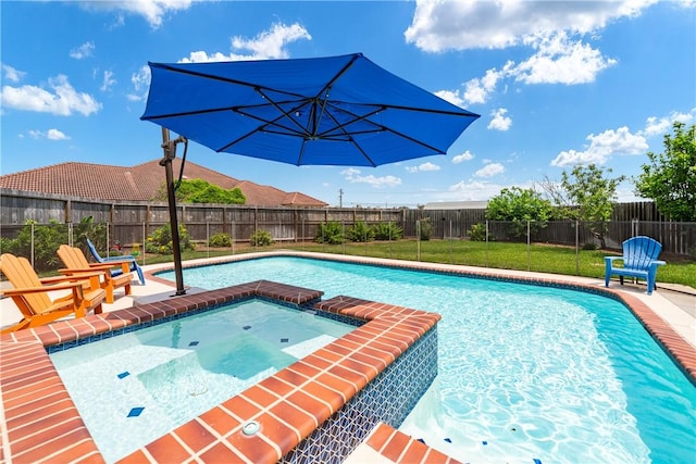 view of swimming pool featuring a fenced backyard, a pool with connected hot tub, and a yard