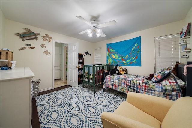bedroom with ceiling fan and baseboards