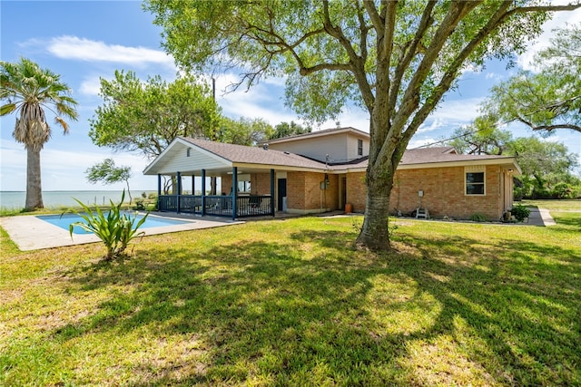 back of house featuring a yard and a patio