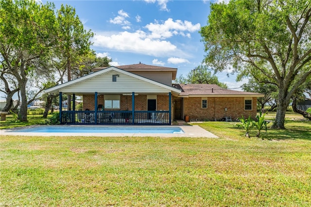 rear view of property with a yard