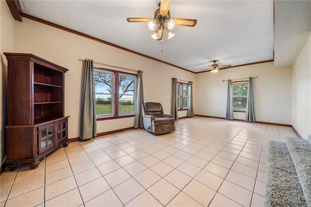 unfurnished room with ornamental molding, a textured ceiling, ceiling fan, and light tile patterned flooring