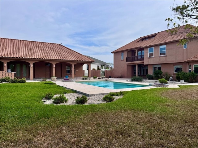 outdoor pool featuring a yard