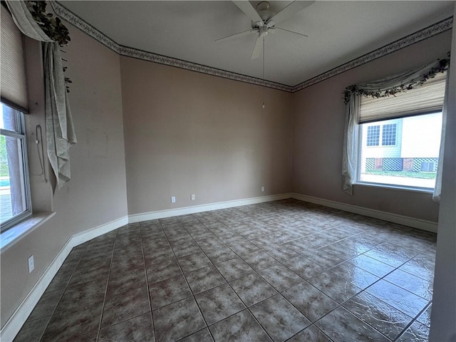 unfurnished room featuring tile patterned flooring, ceiling fan, and baseboards