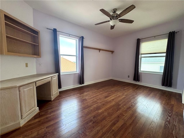 interior space with dark wood-style flooring, built in desk, and plenty of natural light