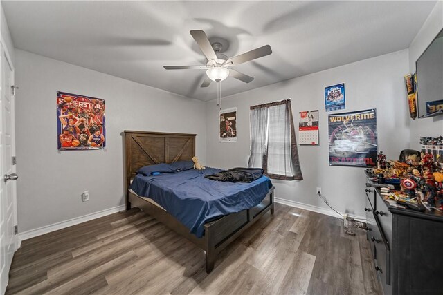 702 W 1st St, Bishop, TX 78343 - bedroom featuring baseboards, ceiling fan, and wood finished floors