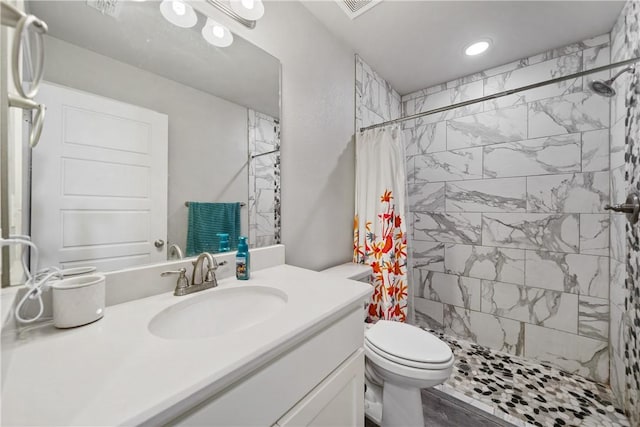 702 W 1st St, Bishop, TX 78343 - bathroom with visible vents, toilet, a tile shower, recessed lighting, and vanity