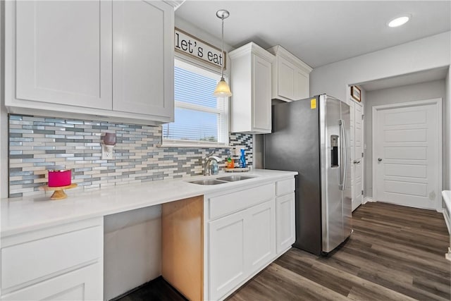 702 W 1st St, Bishop, TX 78343 - kitchen featuring dark wood-style flooring, backsplash, white cabinets, a sink, and hanging light fixtures