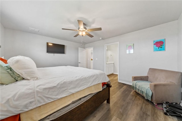 702 W 1st St, Bishop, TX 78343 - bedroom with baseboards, connected bathroom, visible vents, ceiling fan, and wood finished floors
