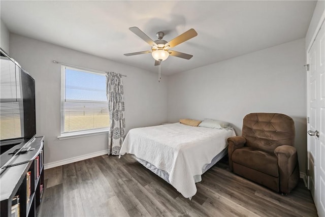 702 W 1st St, Bishop, TX 78343 - bedroom with dark wood-type flooring, baseboards, and ceiling fan