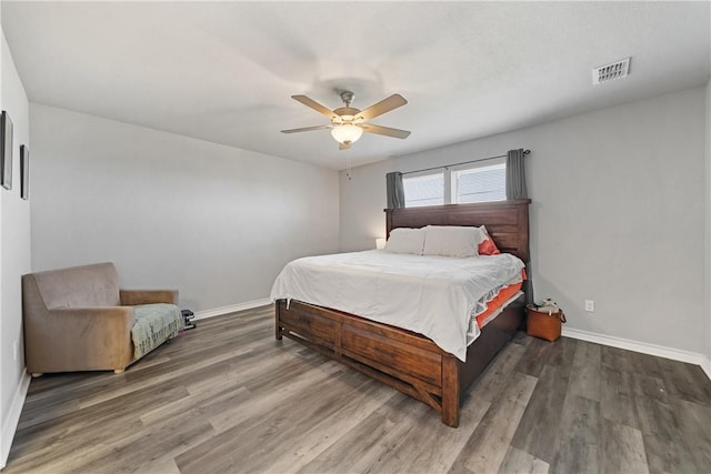 702 W 1st St, Bishop, TX 78343 - bedroom featuring wood finished floors, ceiling fan, baseboards, and visible vents