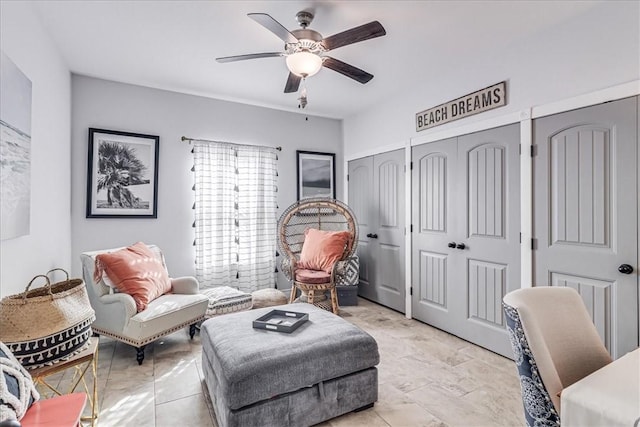 living area with a ceiling fan