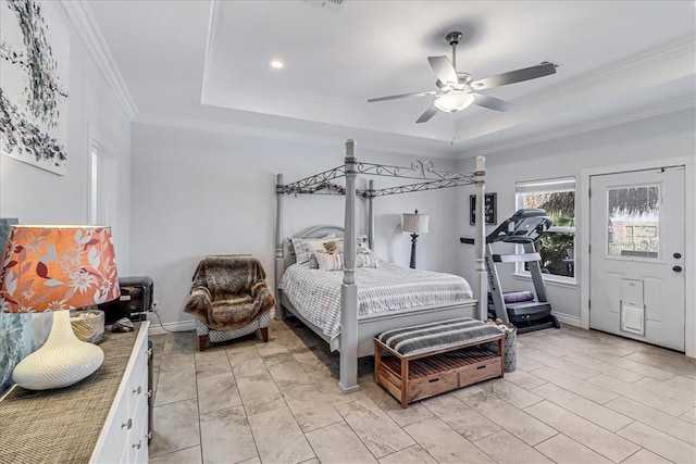 bedroom featuring ceiling fan, baseboards, a tray ceiling, and ornamental molding