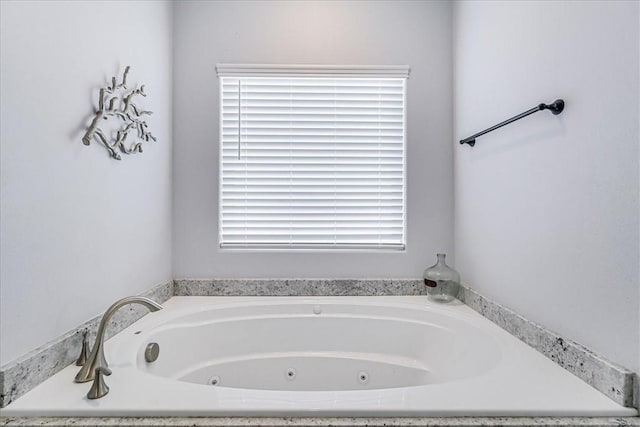 full bathroom with a jetted tub