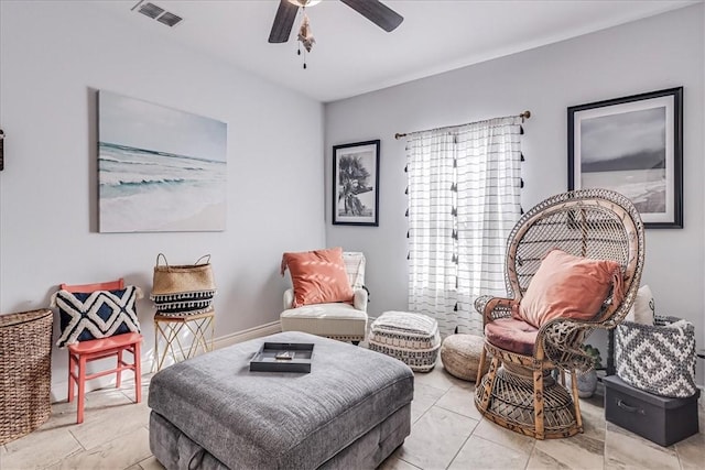 sitting room with visible vents and ceiling fan