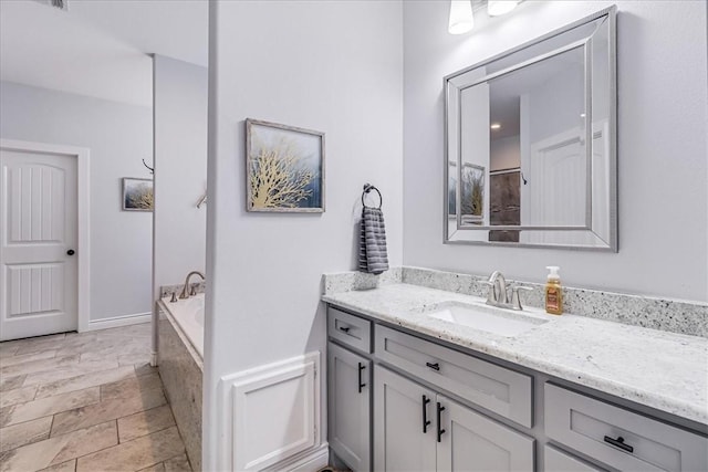 full bathroom with a bath and vanity