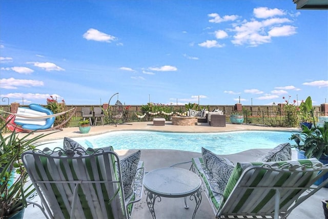 view of swimming pool with a patio and a fenced in pool