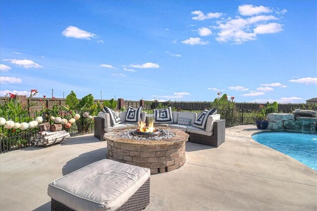 view of patio / terrace featuring fence, a fenced in pool, and an outdoor fire pit