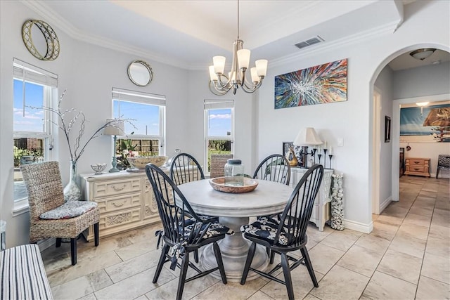 dining space featuring visible vents, baseboards, arched walkways, crown molding, and a notable chandelier