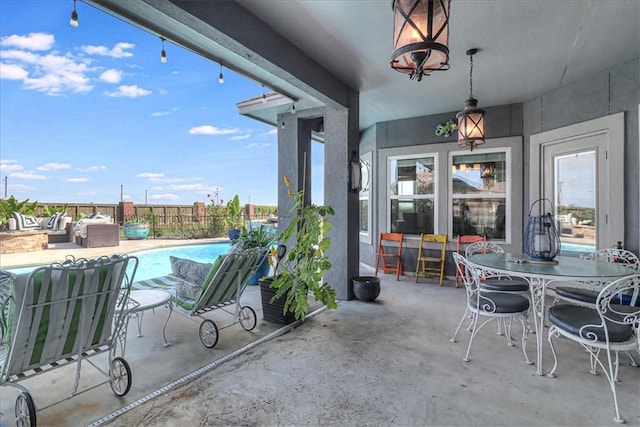 view of patio / terrace with outdoor dining space, an outdoor living space, fence, and a fenced in pool