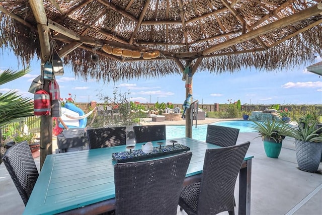 view of patio featuring a gazebo, outdoor dining area, a fenced in pool, and a fenced backyard