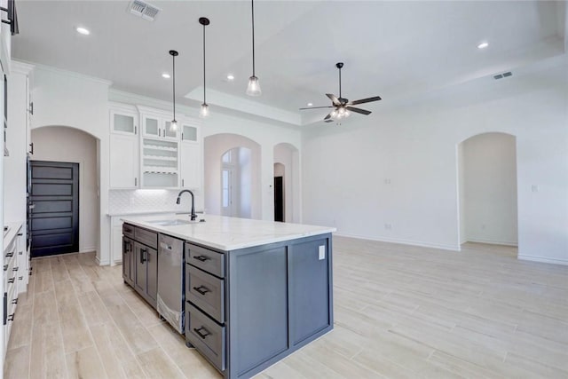 kitchen with gray cabinetry, a kitchen island with sink, sink, tasteful backsplash, and white cabinetry