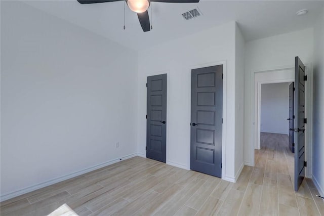 unfurnished bedroom with ceiling fan and light hardwood / wood-style flooring