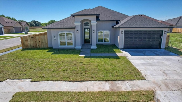 view of front facade with a front yard and a garage