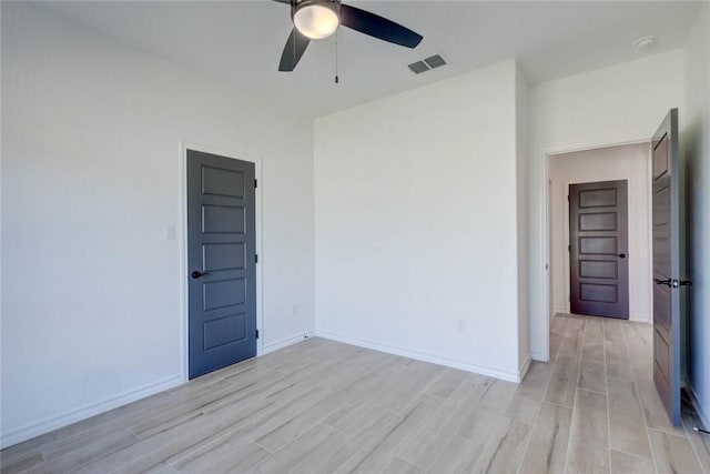 unfurnished room featuring ceiling fan and light wood-type flooring