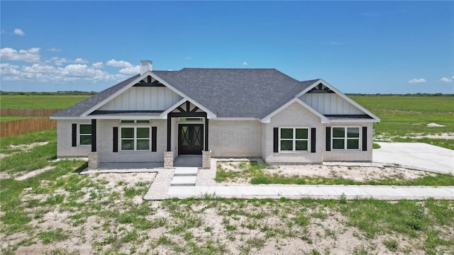 craftsman-style house with a patio and a rural view