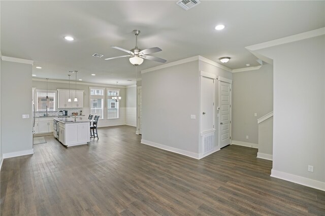 unfurnished living room with dark hardwood / wood-style flooring, sink, crown molding, and ceiling fan