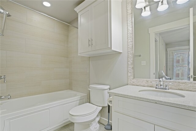 full bathroom with toilet, vanity, and tiled shower / bath