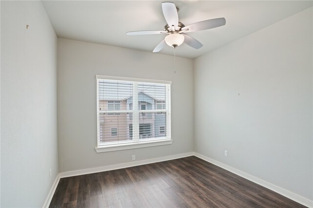 empty room featuring dark hardwood / wood-style flooring and ceiling fan