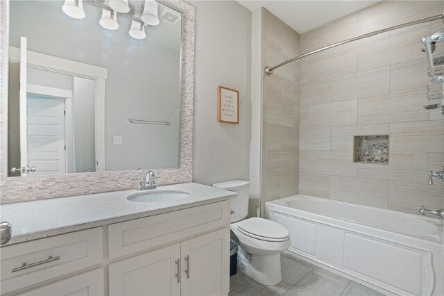 full bathroom featuring tile patterned floors, vanity, toilet, and tiled shower / bath combo