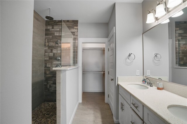 bathroom with vanity and tiled shower